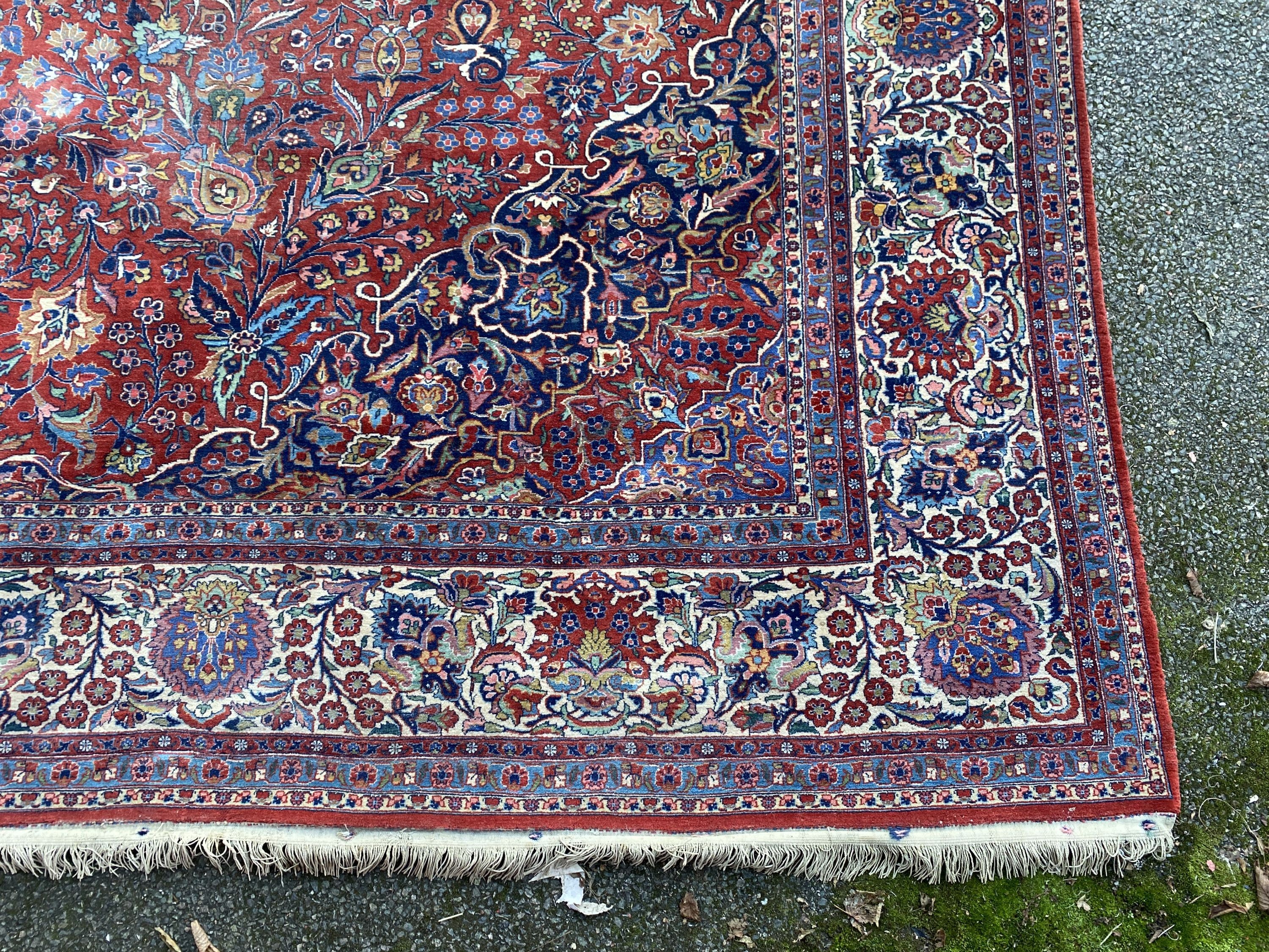 A Tabriz red ground carpet with, first half 20th century, 510cm x 355cm